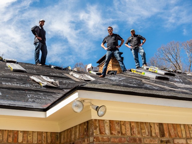 roofers on the roof of a house