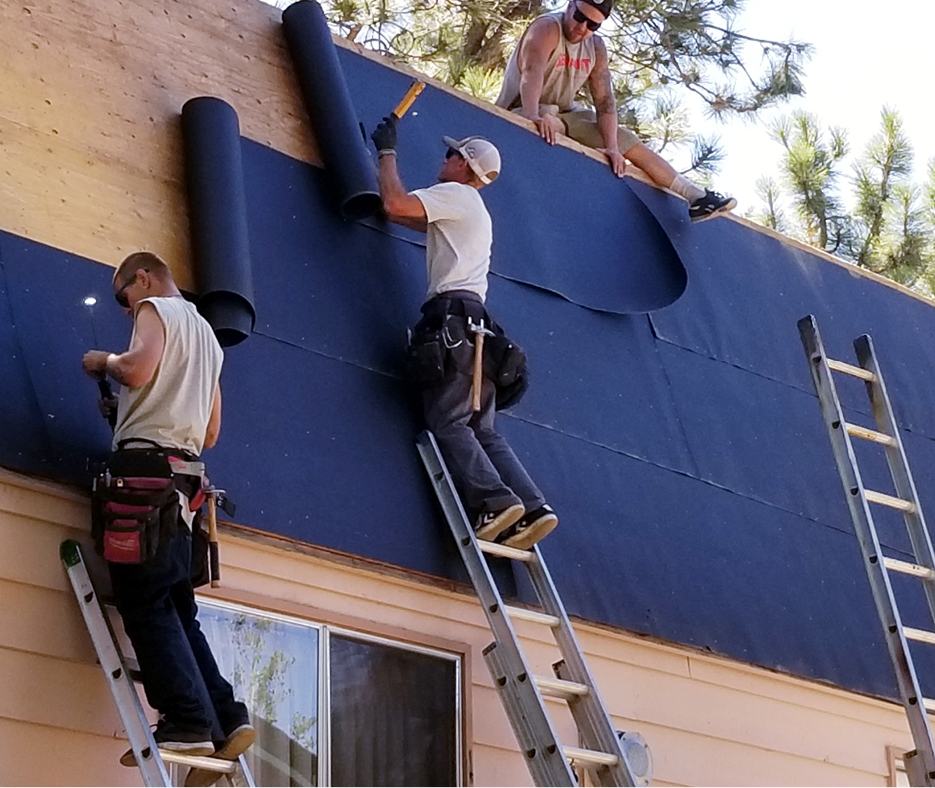 craftsmen install the roof